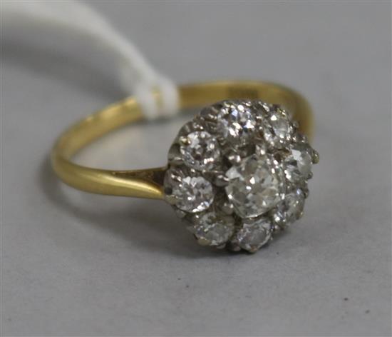 An 18ct gold and diamond cluster ring, size J.